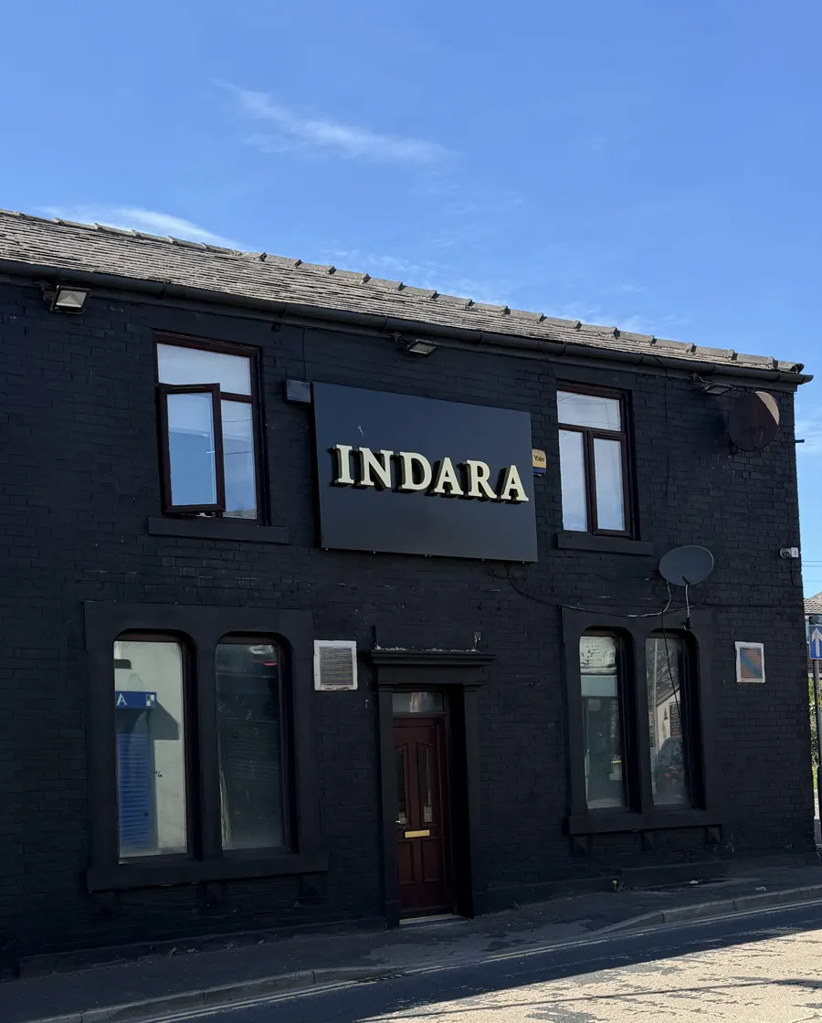 Our black-painted building on Whitworth Road with the gold INDARA sign
