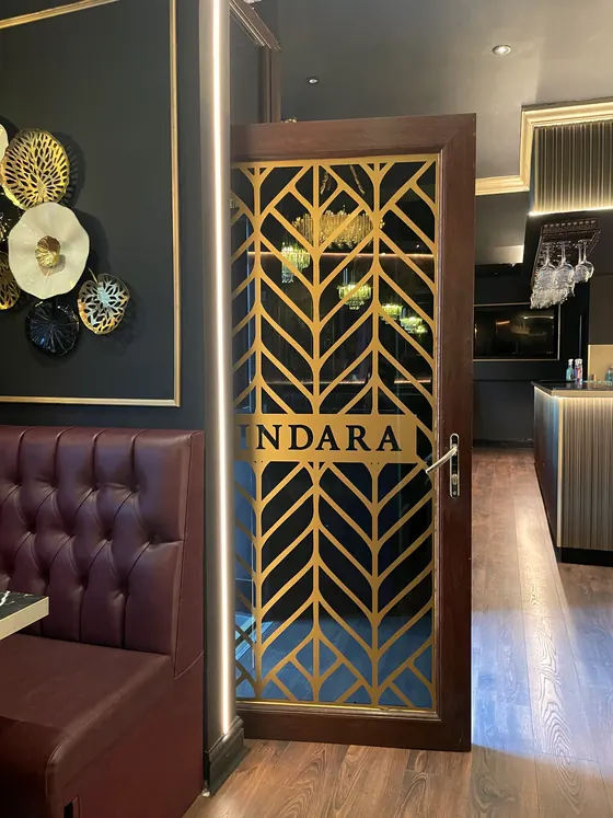 The gold chevron door with the INDARA plate