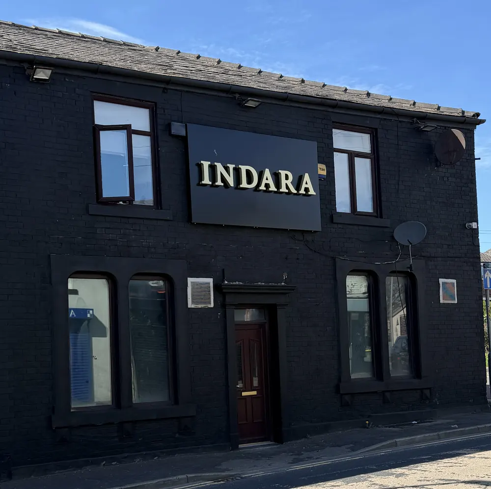 Indara's shop front: a black-painted building with a gold INDARA sign
